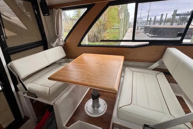 Slide: The Image of 2026 Cutwater C-248 Coupe interior with white leather seating and wood accents. - 19