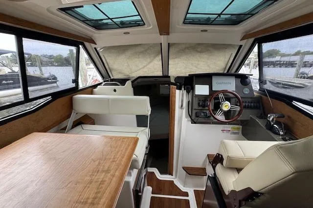 Slide: The Image of 2026 Cutwater C-248 Coupe interior with wooden table and white seating. - 21