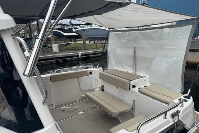 Slide: The Image of 2026 Cutwater C-248 Coupe interior with helm, seating, and wooden table. - 23