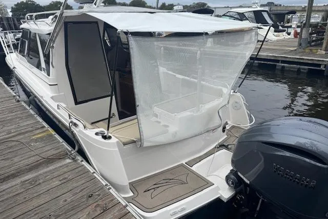 Slide: The Image of 2026 Cutwater C-248 Coupe boat interior with beige seating and deck details. - 24