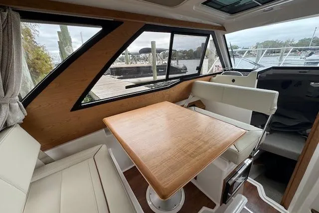 Slide: The Image of 2026 Cutwater C-248 Coupe boat interior with seating and canopy at a marina. - 25