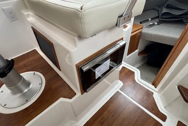 Slide: The Image of 2026 Cutwater C-248 Coupe boat on trailer, parked outdoors under blue sky. - 29