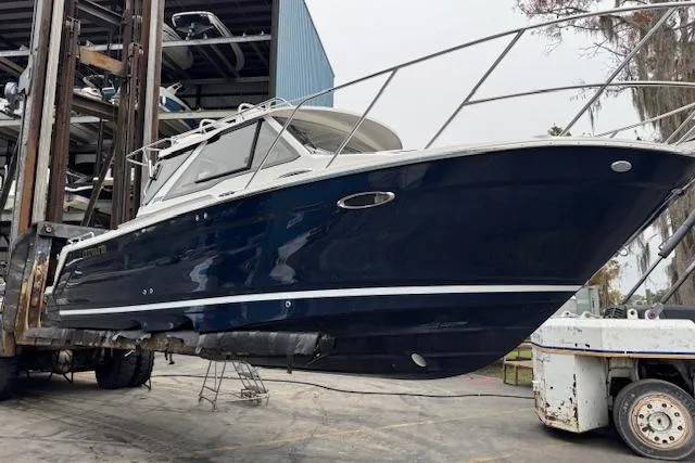 Slide: The Image of 2026 Cutwater C-248 Coupe boat docked at marina, featuring sleek design and modern amenities. - 3