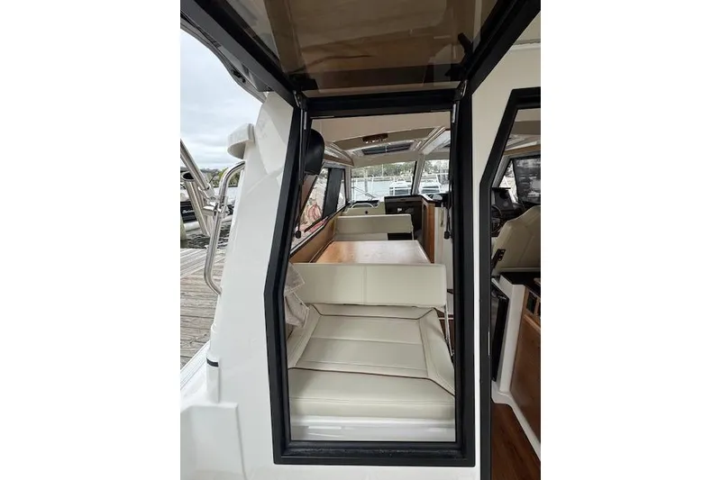 Slide: The Image of 2026 Cutwater C-248 Coupe interior with stainless steel fridge and wooden flooring. - 31