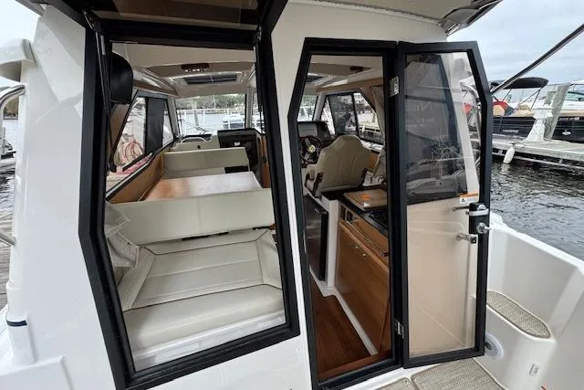 Slide: The Image of Interior of 2026 Cutwater C-248 Coupe boat with wood flooring and seating. - 32