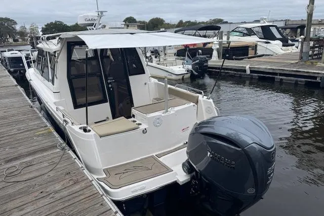 Slide: The Image of 2026 Cutwater C-248 Coupe interior view at dock, showcasing seating and helm area. - 33
