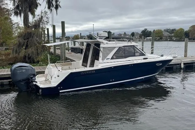 Slide: The Image of 2026 Cutwater C-248 Coupe boat docked on a calm waterfront. - 37
