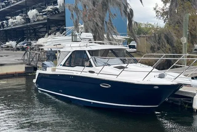 Slide: The Image of 2026 Cutwater C-248 Coupe boat docked at marina, sleek design, blue hull. - 38