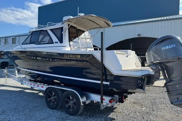 Slide: The Image of 2026 Cutwater C-248 Coupe boat on trailer, Yamaha engine, parked outdoors. - 43