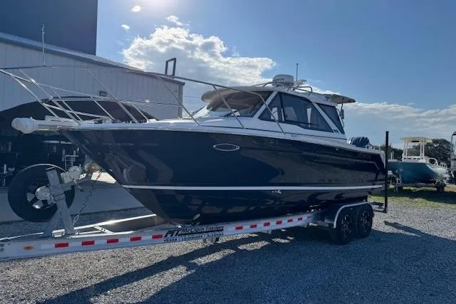 Slide: The Image of 2026 Cutwater C-248 Coupe boat on trailer, parked outdoors under a clear sky. - 45