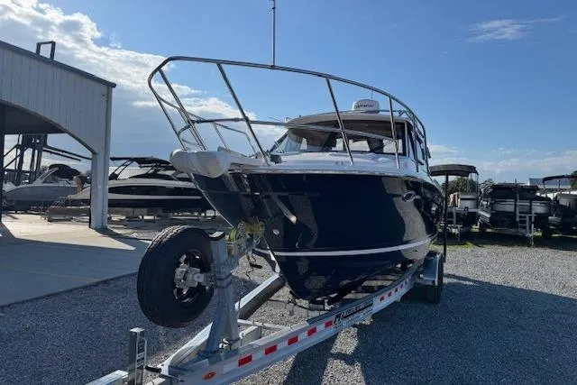 Slide: The Image of 2026 Cutwater C-248 Coupe boat on trailer, parked outdoors under clear sky. - 48