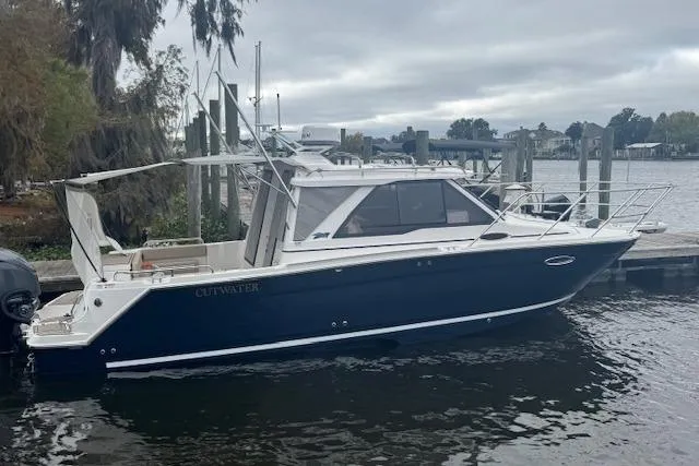 Slide: The Image of 2026 Cutwater C-248 Coupe boat on dry dock near marine facility. - 8