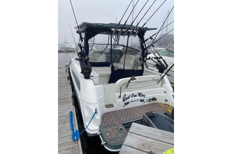 The Image of 2004 Regal Commodore 2860 boat docked, equipped with fishing rods and canopy. - 0