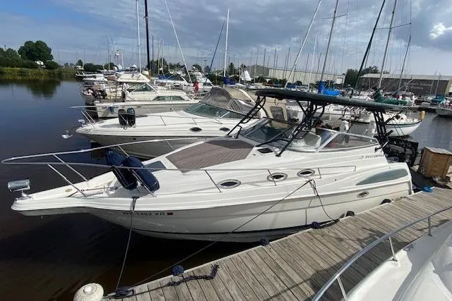 Slide: The Image of 2004 Regal Commodore 2860 boat docked in a marina, surrounded by other vessels. - 3