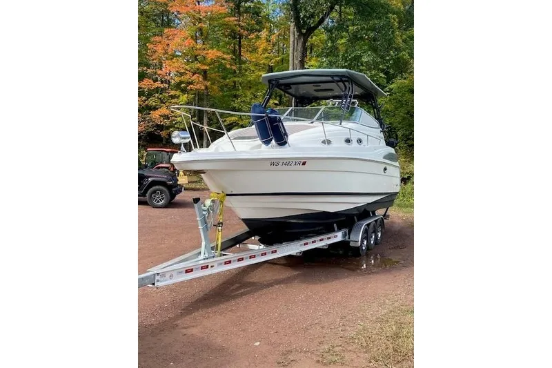 Slide: The Image of 2004 Regal Commodore 2860 boat on trailer, surrounded by autumn trees. - 4