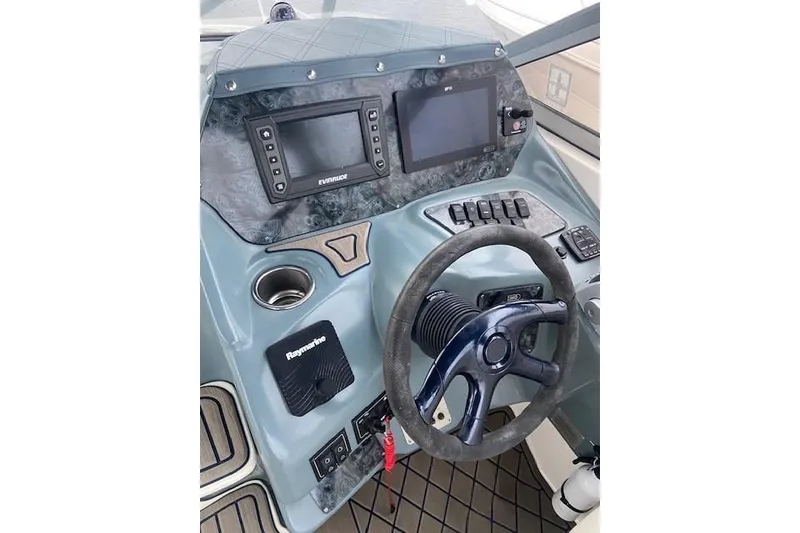 Slide: The Image of 2004 Regal Commodore 2860 helm with steering wheel, navigation screens, and control panel. - 6
