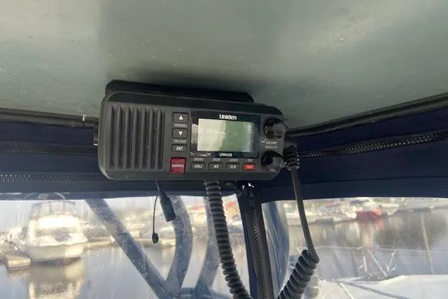 Slide: The Image of VHF radio installed on a 2004 Regal Commodore 2860 boat, with marina view. - 9