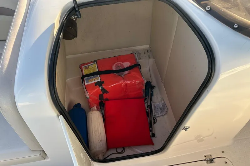 Slide: The Image of Storage compartment in a 2005 Chaparral Sunesta 252 boat with life jackets and safety gear. - 10
