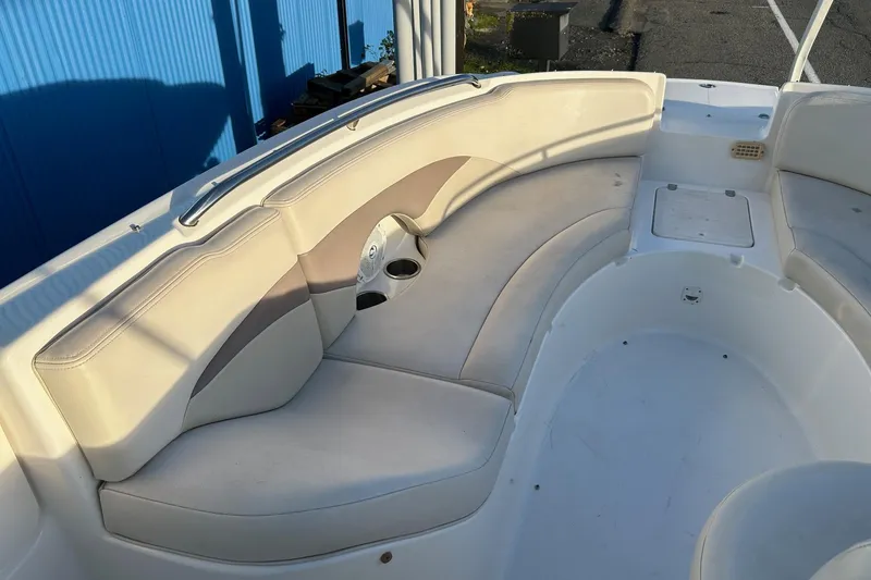 Slide: The Image of 2005 Chaparral Sunesta 252 boat interior with beige seating and cup holders. - 11