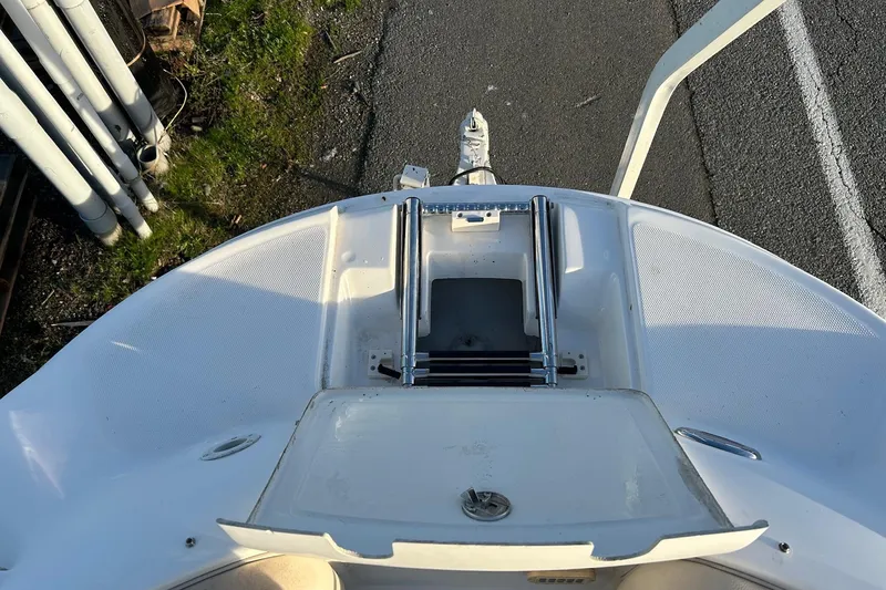 Slide: The Image of 2005 Chaparral Sunesta 252 boat bow with ladder, parked on pavement. - 14