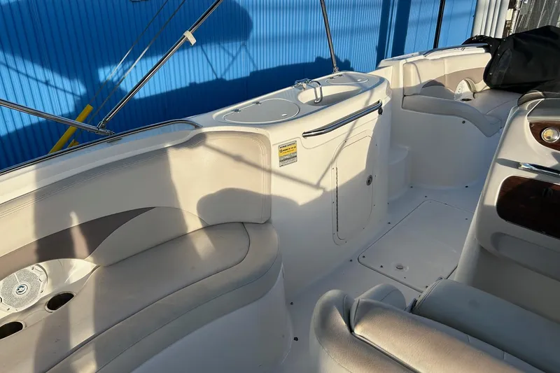 Slide: The Image of 2005 Chaparral Sunesta 252 boat interior with seating and storage compartments. - 19