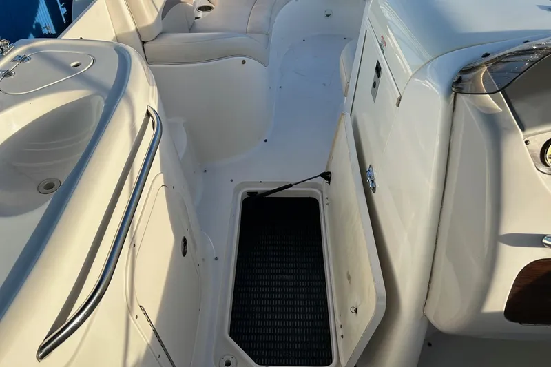 Slide: The Image of 2005 Chaparral Sunesta 252 boat interior with open storage compartment and seating area. - 21