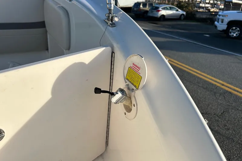 Slide: The Image of 2005 Chaparral Sunesta 252 boat interior with fuel cap and warning label. - 24