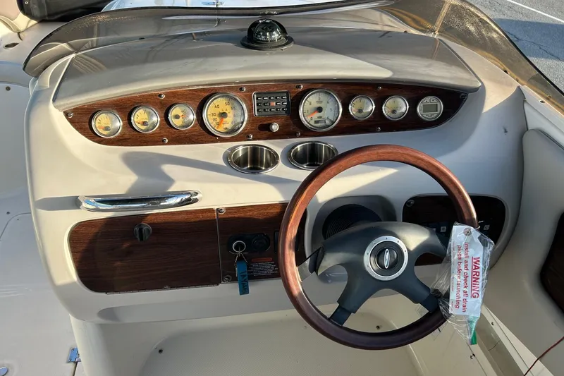 Slide: The Image of 2005 Chaparral Sunesta 252 dashboard with wood accents and steering wheel. - 8