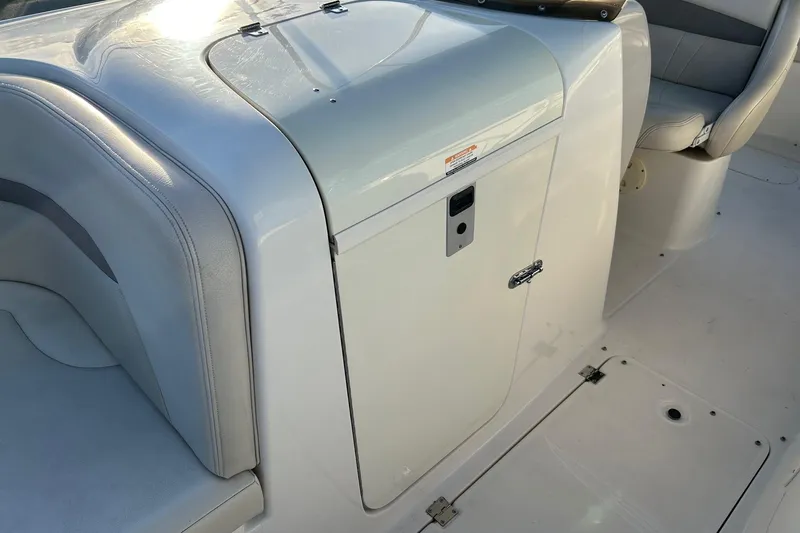 Slide: The Image of 2005 Chaparral Sunesta 252 boat interior, featuring seating and storage compartment. - 9