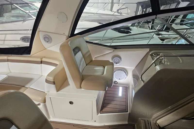 Slide: The Image of 2012 Sea Ray 370 Sundancer interior with beige seating and modern design. - 16