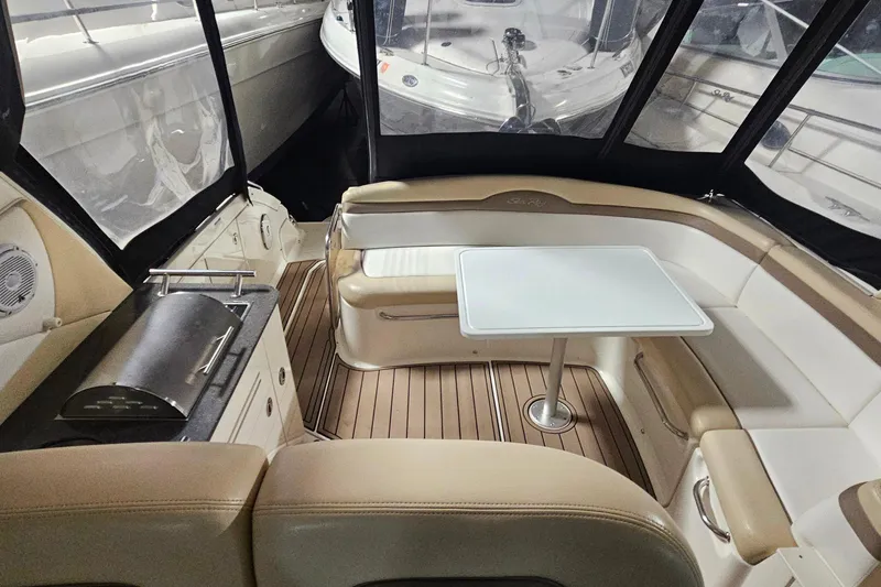 Slide: The Image of Interior of 2012 Sea Ray 370 Sundancer with seating, table, and grill. - 18