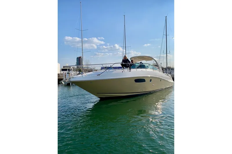 Slide: The Image of 2012 Sea Ray 370 Sundancer yacht on calm water under a clear blue sky. - 2