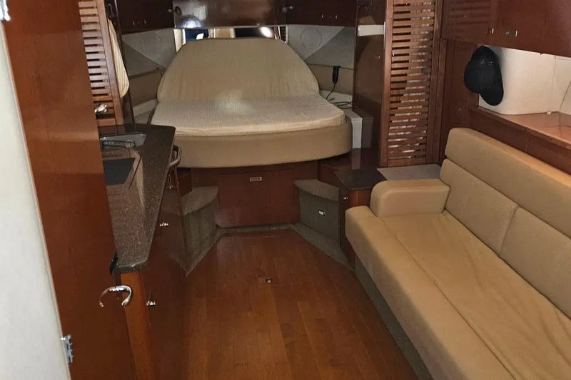Slide: The Image of Luxurious interior of 2012 Sea Ray 370 Sundancer with bed and seating area. - 20