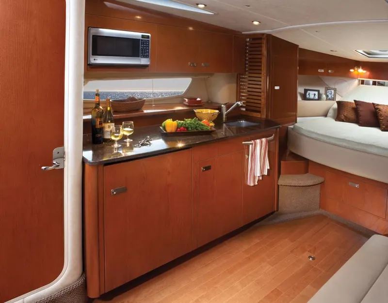 Slide: The Image of Manufacturer Provided Image: Luxurious interior of 2012 Sea Ray 370 Sundancer yacht with kitchen and cozy seating area. - 21