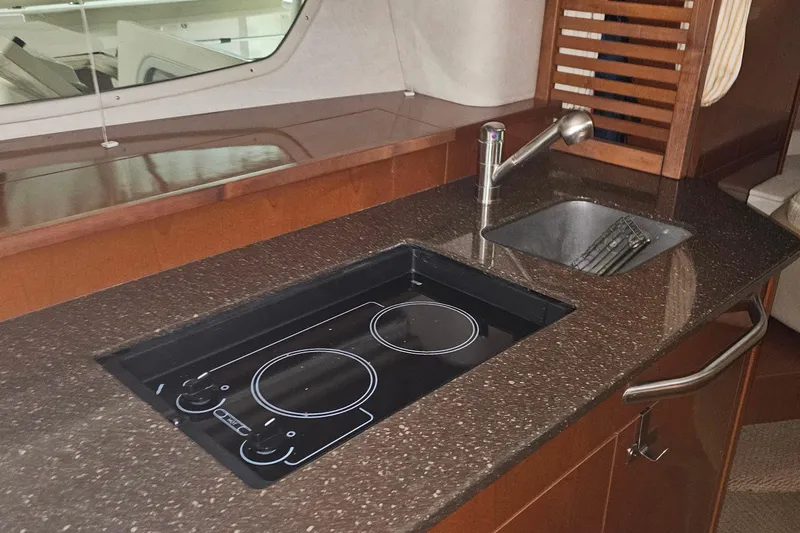 Slide: The Image of Luxury kitchen area in 2012 Sea Ray 370 Sundancer yacht with stove and sink. - 22