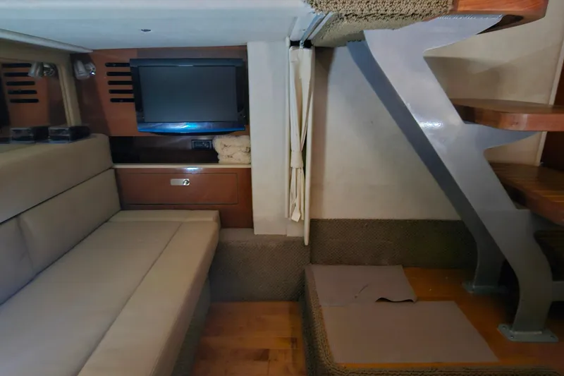 Slide: The Image of Interior of 2012 Sea Ray 370 Sundancer with sofa, TV, and stairs. - 27
