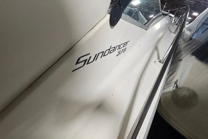 Slide: The Image of 2012 Sea Ray 370 Sundancer boat, side view with model name visible. - 34