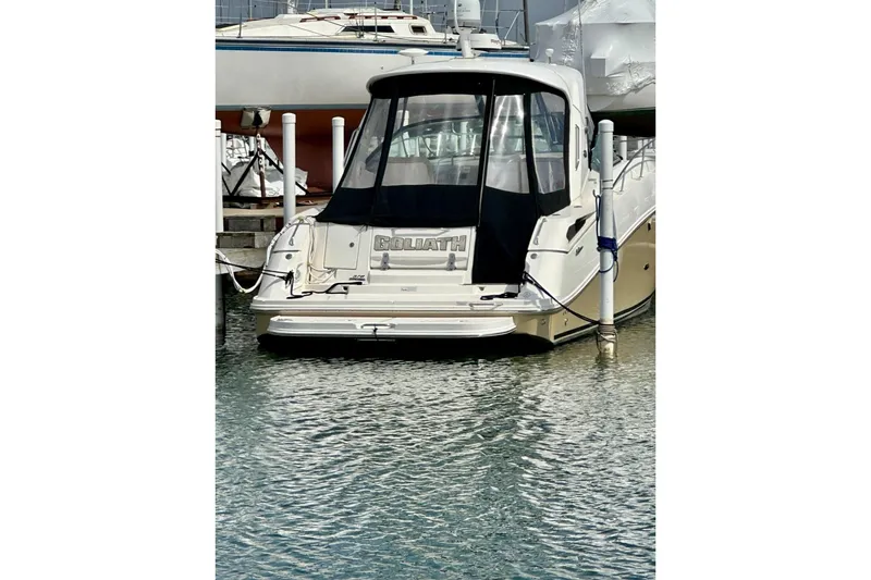 Slide: The Image of Sea Ray 370 Sundancer 2012 docked at marina, rear view with black canopy. - 37