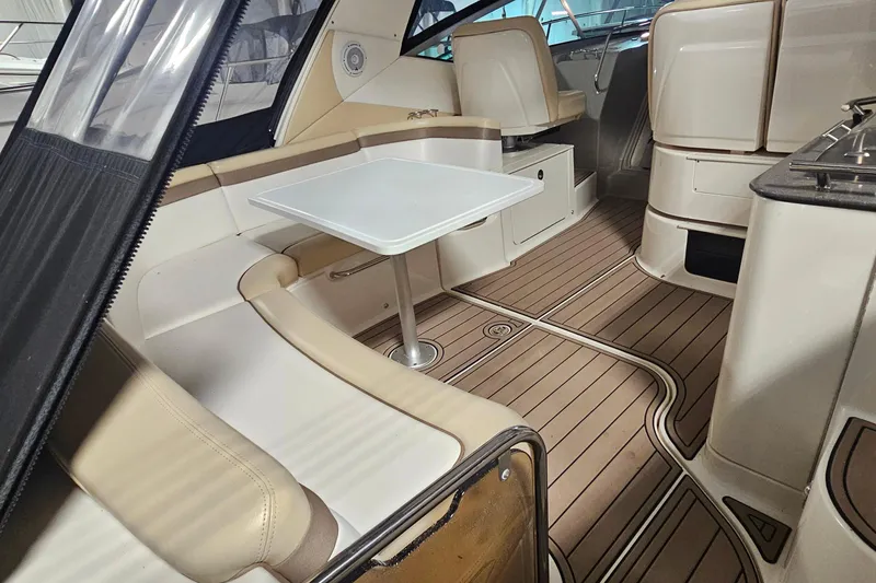 Slide: The Image of Interior of 2012 Sea Ray 370 Sundancer with seating, table, and wood flooring. - 6