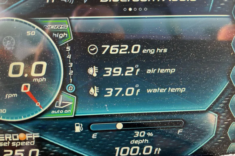 Slide: The Image of Display panel of 2015 Nautique Super Air Nautique G23 showing engine hours and temperatures. - 13
