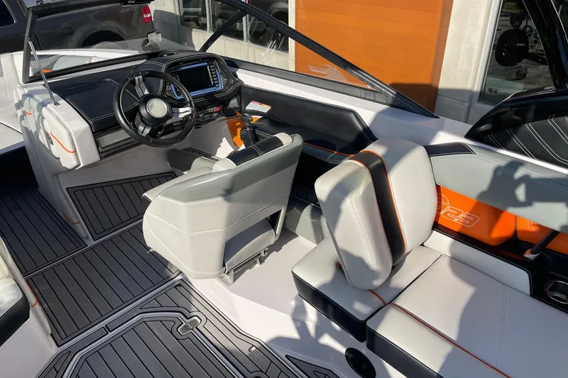 Slide: The Image of 2015 Nautique Super Air Nautique G23 boat interior with modern dashboard and seating. - 6