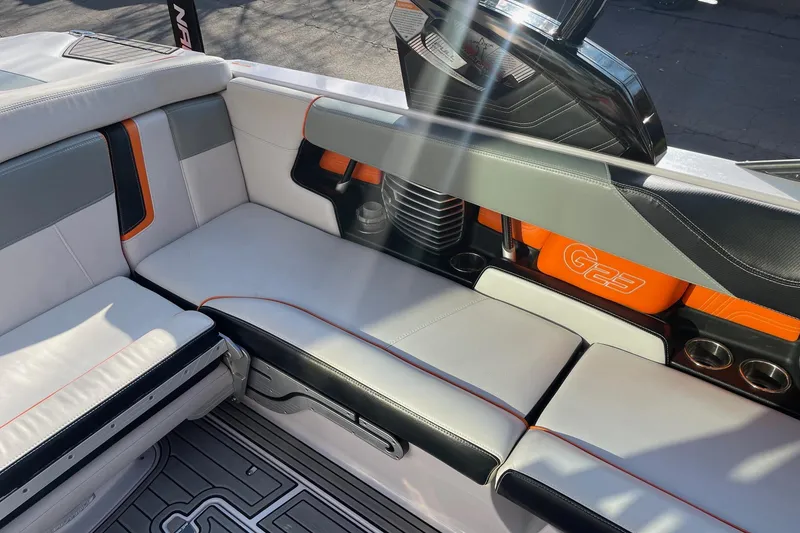Slide: The Image of 2015 Nautique Super Air Nautique G23 interior with stylish seating and cup holders. - 9