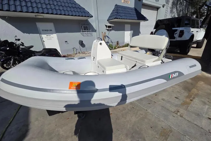 Slide: The Image of 2014 AB Inflatables 10 VSX boat with Honda 30HP engine, parked outdoors. - 7
