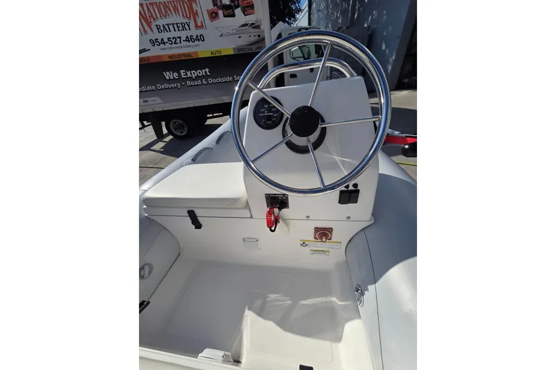 Slide: The Image of 2014 AB Inflatables 10 VSX boat interior with steering wheel and control panel. - 3