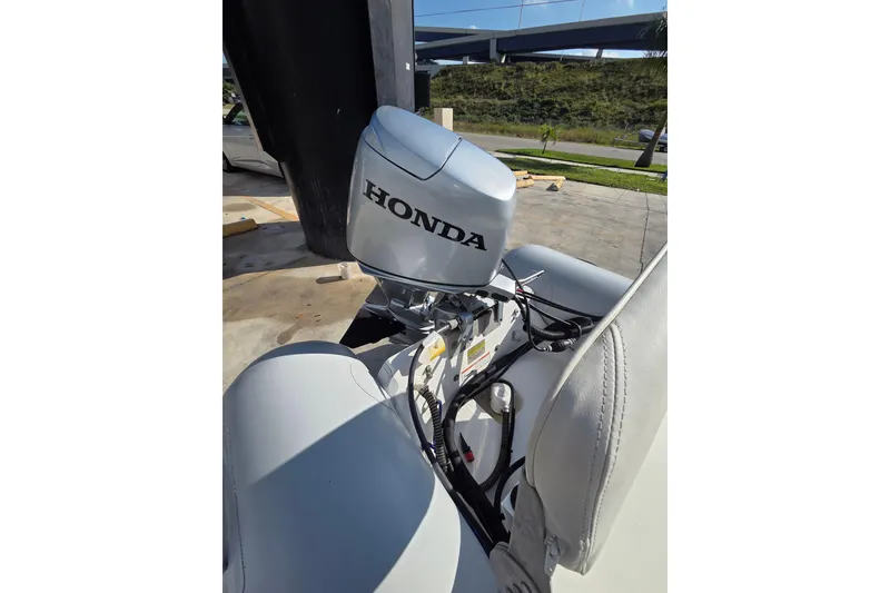 Slide: The Image of 2014 AB Inflatables 10 VSX with Honda outboard motor, parked outdoors. - 4