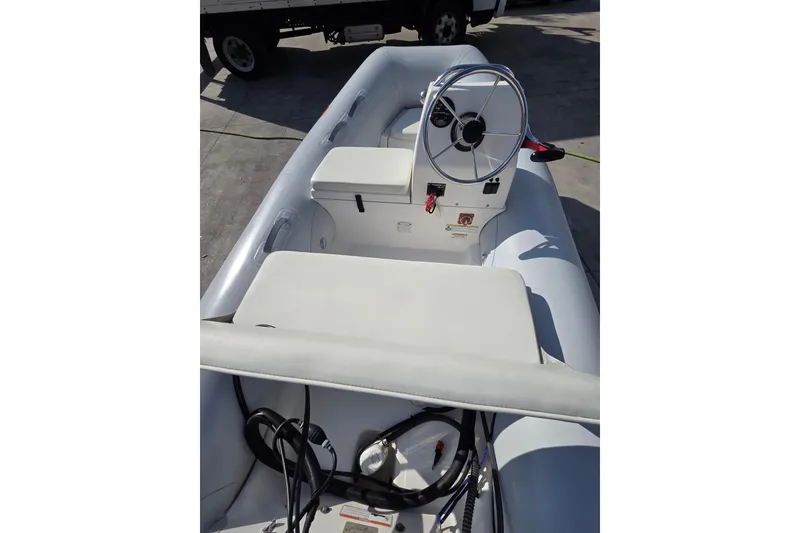 Slide: The Image of 2014 AB Inflatables 10 VSX boat interior with steering wheel and seating. - 5