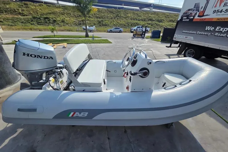 Slide: The Image of 2014 AB Inflatables 10 VSX boat with Honda 30HP engine, parked outdoors. - 6