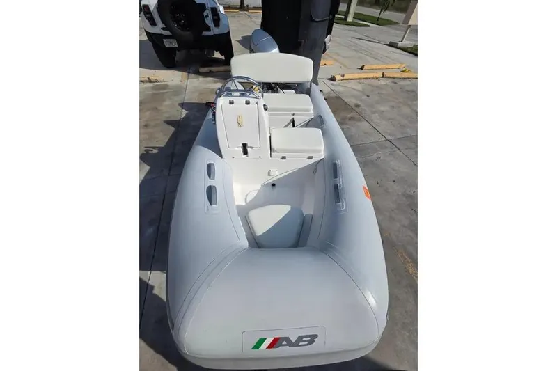 Slide: The Image of 2014 AB Inflatables 10 VSX boat with Honda 30HP engine, docked outdoors. - 9