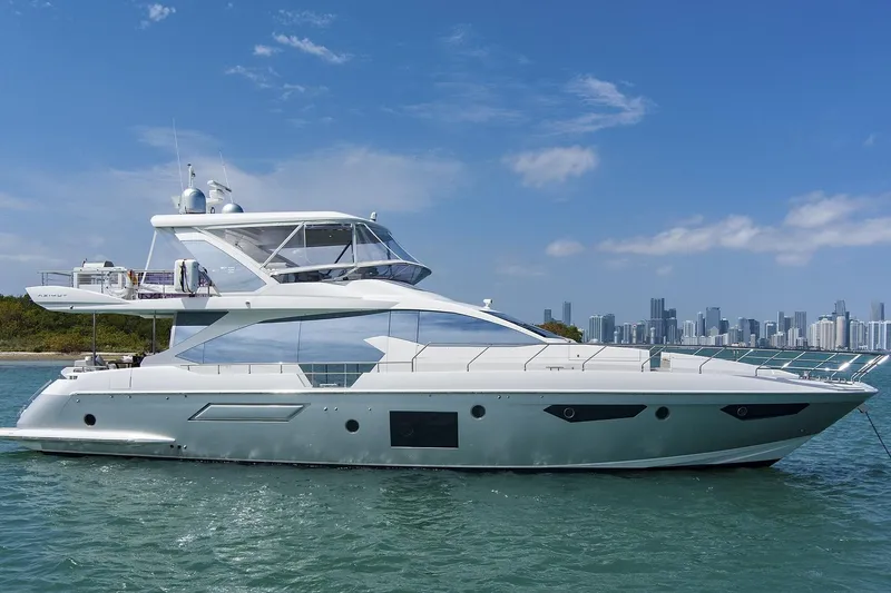The Image of 2017 Azimut 72 Flybridge yacht on water with city skyline in background. - 1