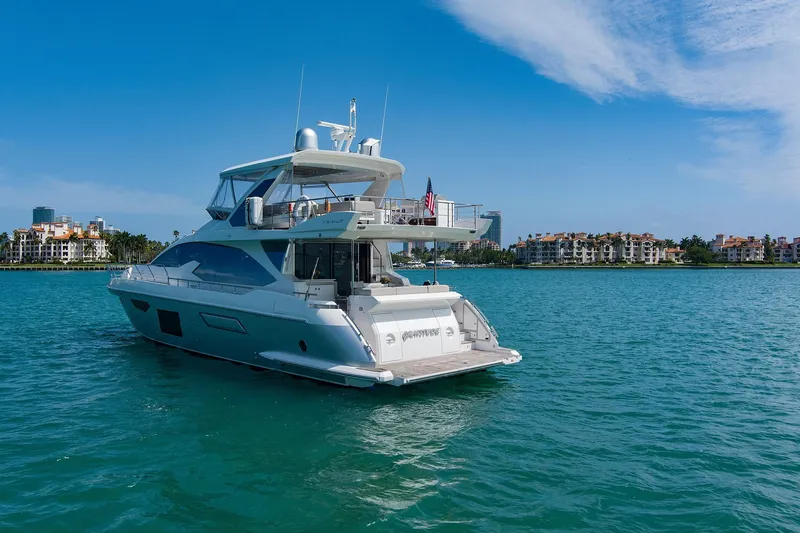 Slide: The Image of Luxury 2017 Azimut 72 Flybridge yacht cruising on clear blue waters. - 4